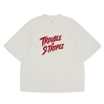 Trouble in St. Tropez Tee unisex cotton t-shirt in off-white by Creo Studios