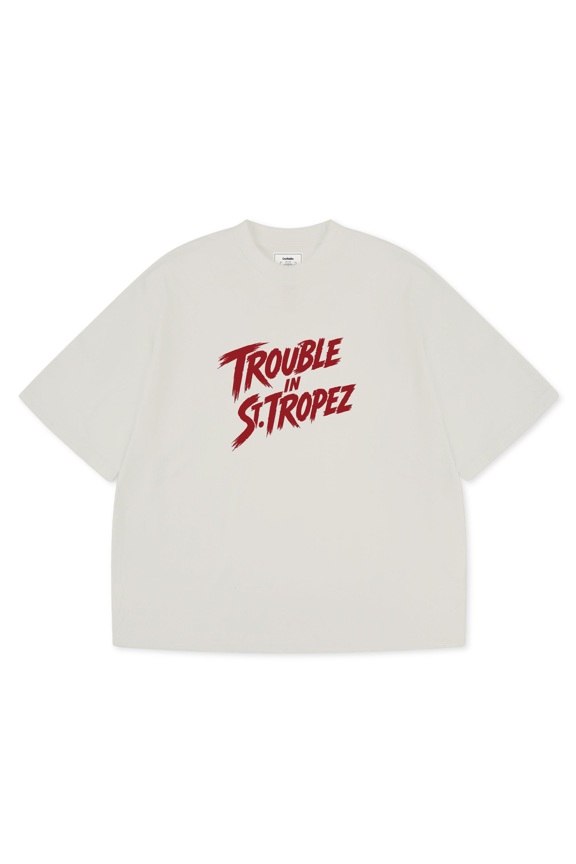Trouble in St. Tropez Tee unisex cotton t-shirt in off-white by Creo Studios